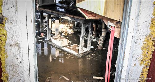 Flooded basement after asbestos abatement contractors broke the main water main
